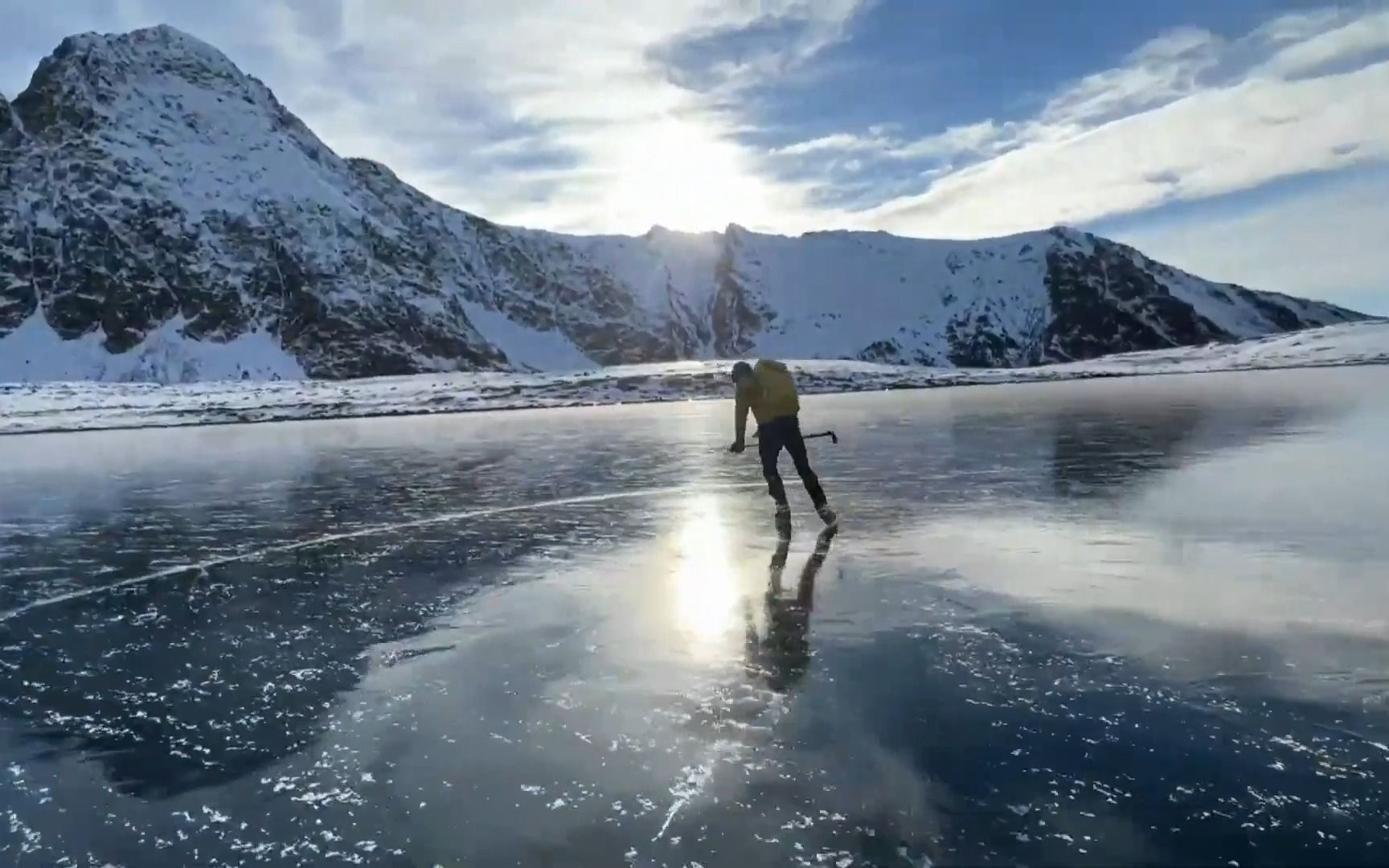 Alaskan skaters glide over astonishingly clear ice on an alpine lake