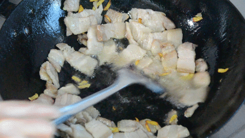 紧接着往锅中再倒入菜油,油开,放入姜丝,姜丝爆香,放入回锅肉炒开
