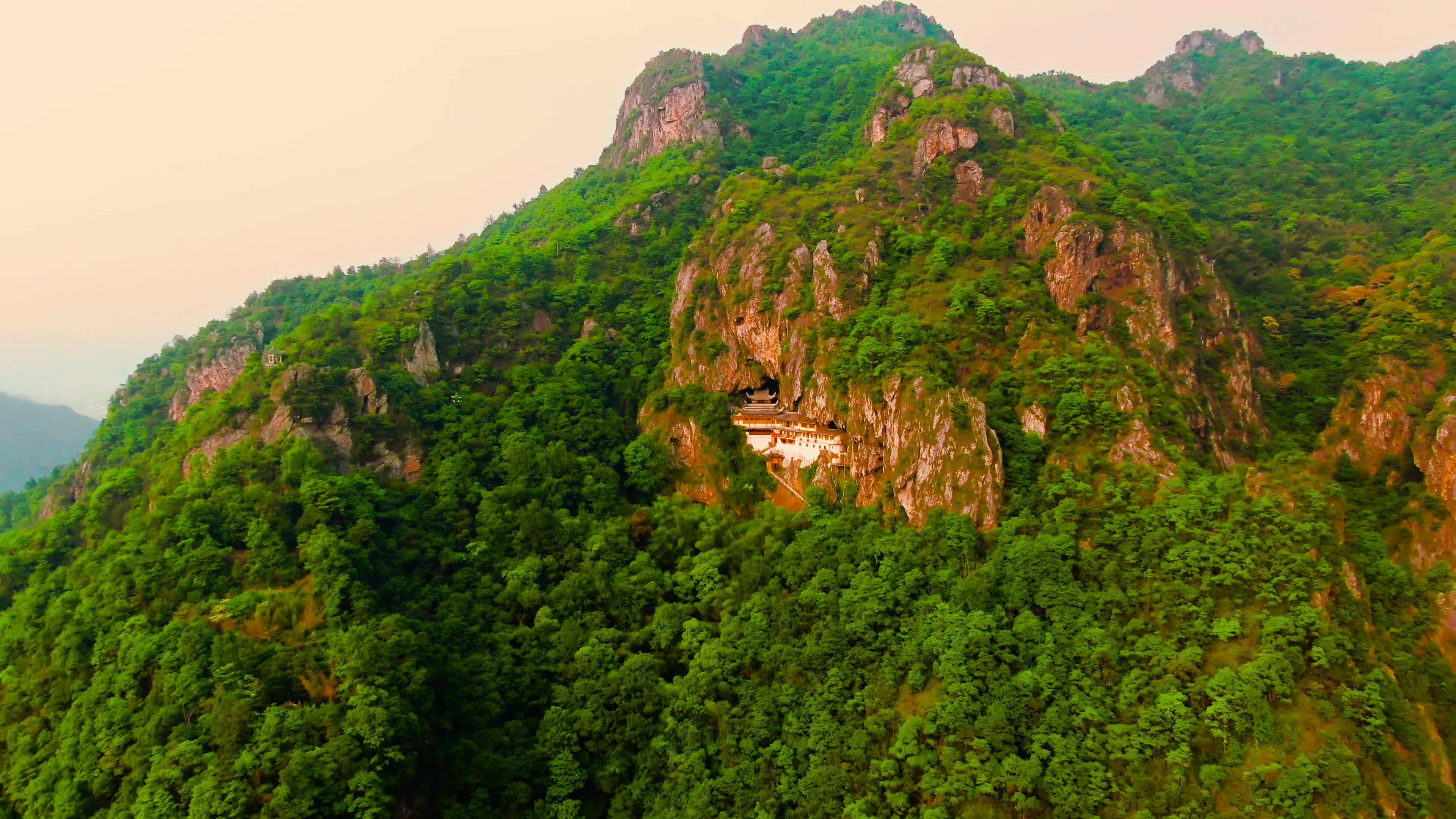 浙江温州市南雁镇,悬挂在半山腰中的观音洞,夕阳下的山峰真美