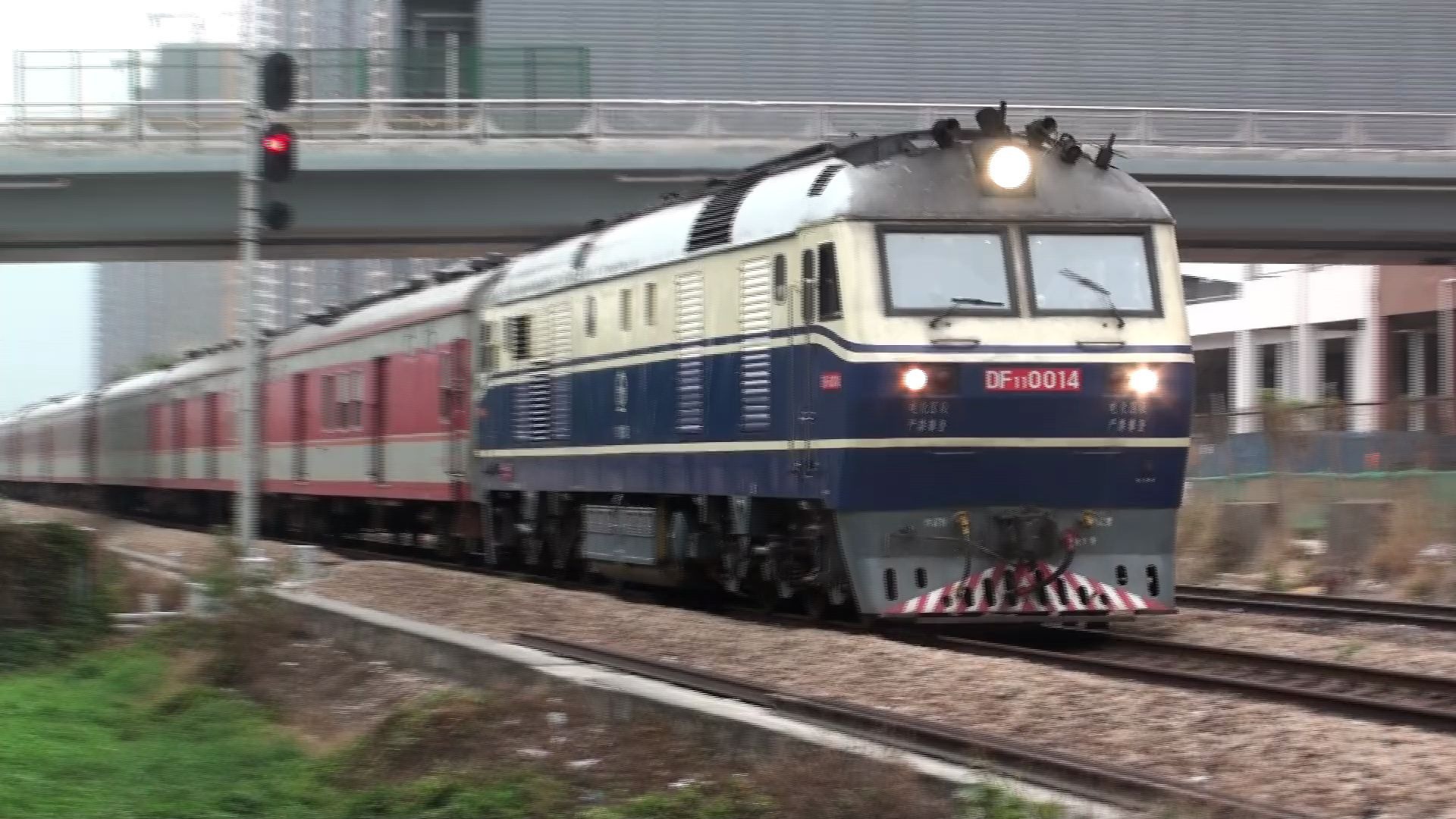 2015年东风110014牵引全列原色25g的旅客列车驶离深圳西站