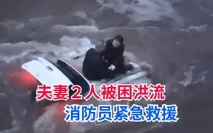 夫妻２人驾车被困洪流之中，洪水猛涨漫过车顶消防员紧急救援