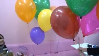 two girls preparing balloons for birthday party