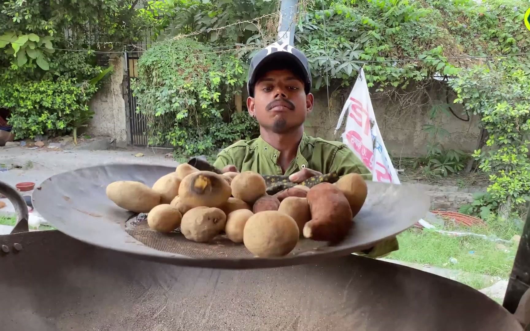 indian vendor cooks potatoes in sand - most epic indian street